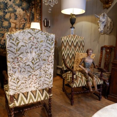 Pair of large carved oak armchairs with scrolls and flamed fabric, Louis XIV period