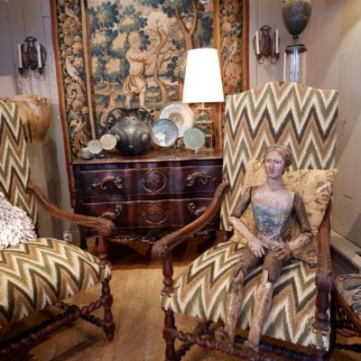 Pair of large carved oak armchairs with scrolls and flamed fabric, Louis XIV period