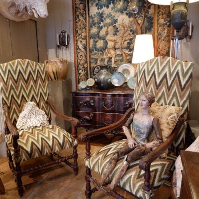 Pair of large carved oak armchairs with scrolls and flamed fabric, Louis XIV period