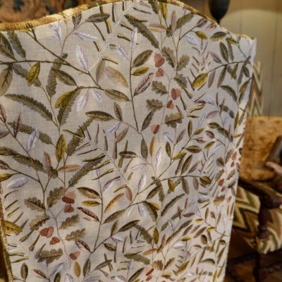 Pair of large carved oak armchairs with scrolls and flamed fabric, Louis XIV period