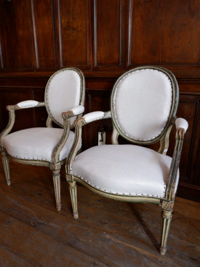 Pair of Louis XVI armchairs with oval medallion backs Green lacquer covered with old linen - France ca.1780