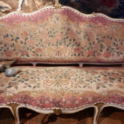 Grande banquette Louis XV recouverte d’une tapisserie au petit point décor de roses ca.1800