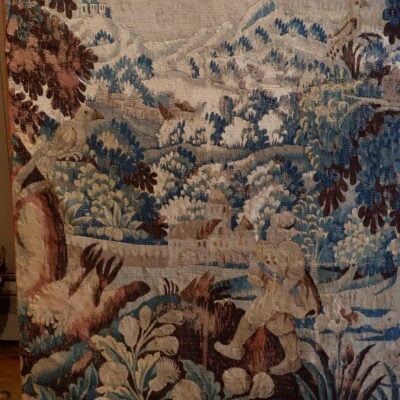 Grande tapisserie d’Aubusson en laine “Chateau dans un paysage de montagne” sur fond de verdure ca.1780