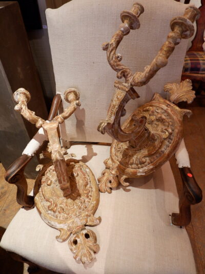 A pair of medallion sconces in carved wood 18th century
