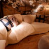 Canapé contemporain en tissu bouclette blanc cassée assise courbe