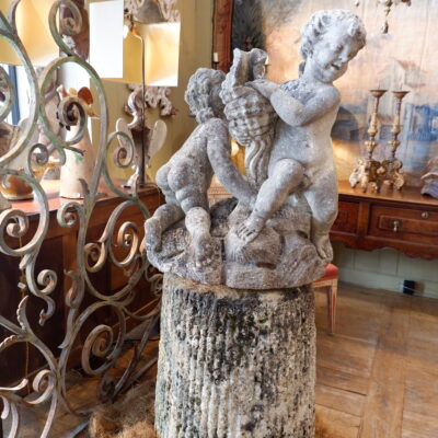 Carved stone fountain center "two putti holding a cornucopia" on a stone base - France