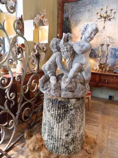 Carved stone fountain center "two putti holding a cornucopia" on a stone base - France