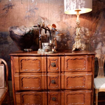 Large double crossbow chest of drawers in carved walnut, 18th century