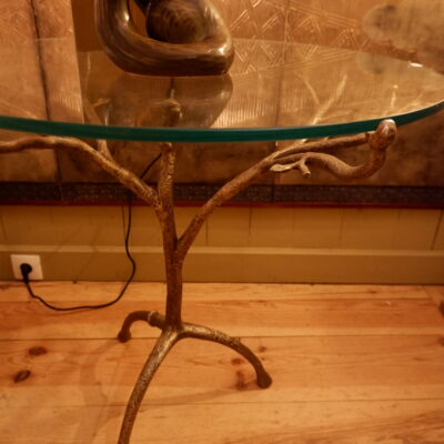 Bronze patina pedestal table with glass top