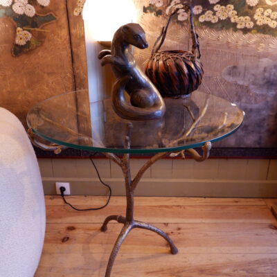 Bronze patina pedestal table with glass top