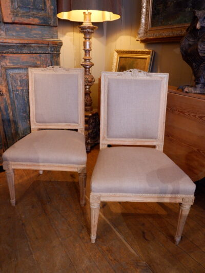 Pair of Gustavian chairs upholstered square back decorated with a carved tulip motif, ca.1800