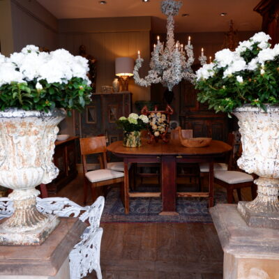 Pair of white cast-iron vases with neo-classical farandole décor and masked handles
