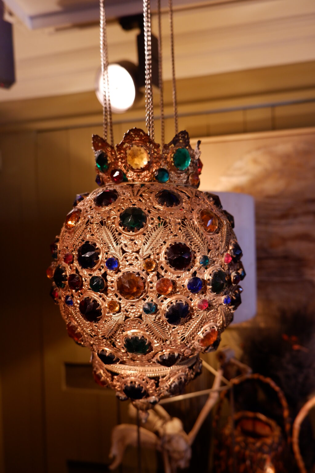 Hanging lamp in openwork gilded sheet metal, decorated with faceted polychrome glass cabochons -France early 20th century