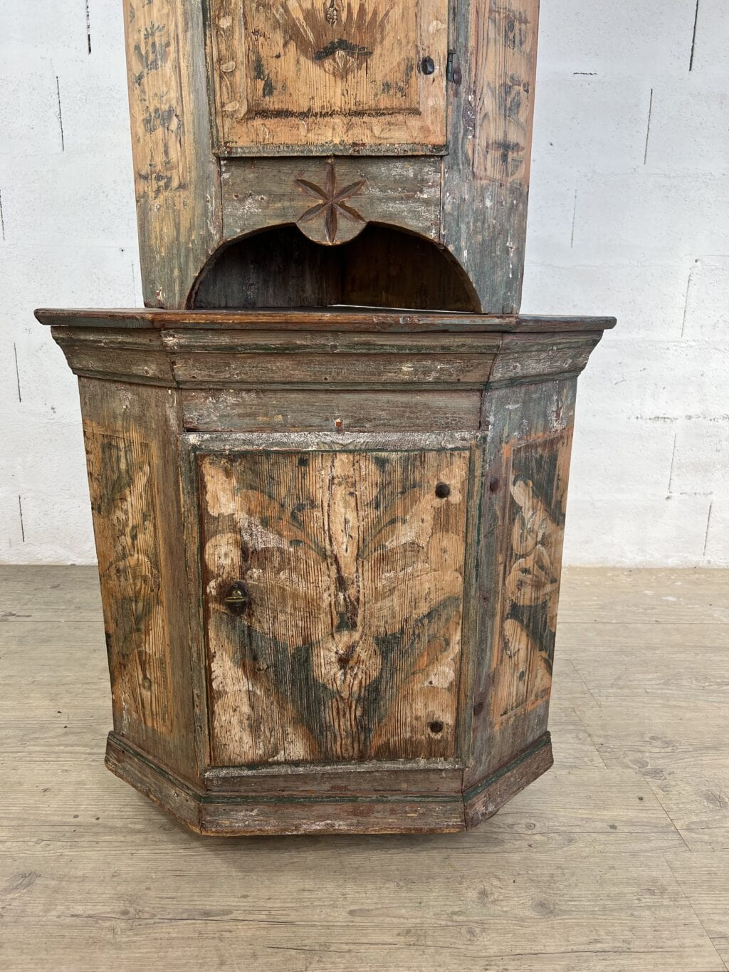 Encoignure suédoise ancienne à deux corps en sapin peint rechampi avec décor floral et niche sculptée
