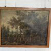 Paire de tableaux italiens anciens représentant des paysages ruraux animés et chasseurs, encadrés en bois de chêne